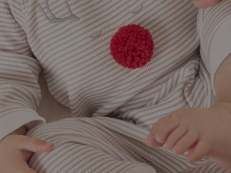 two pictures of a person sitting on a couch with a red button on their shirt