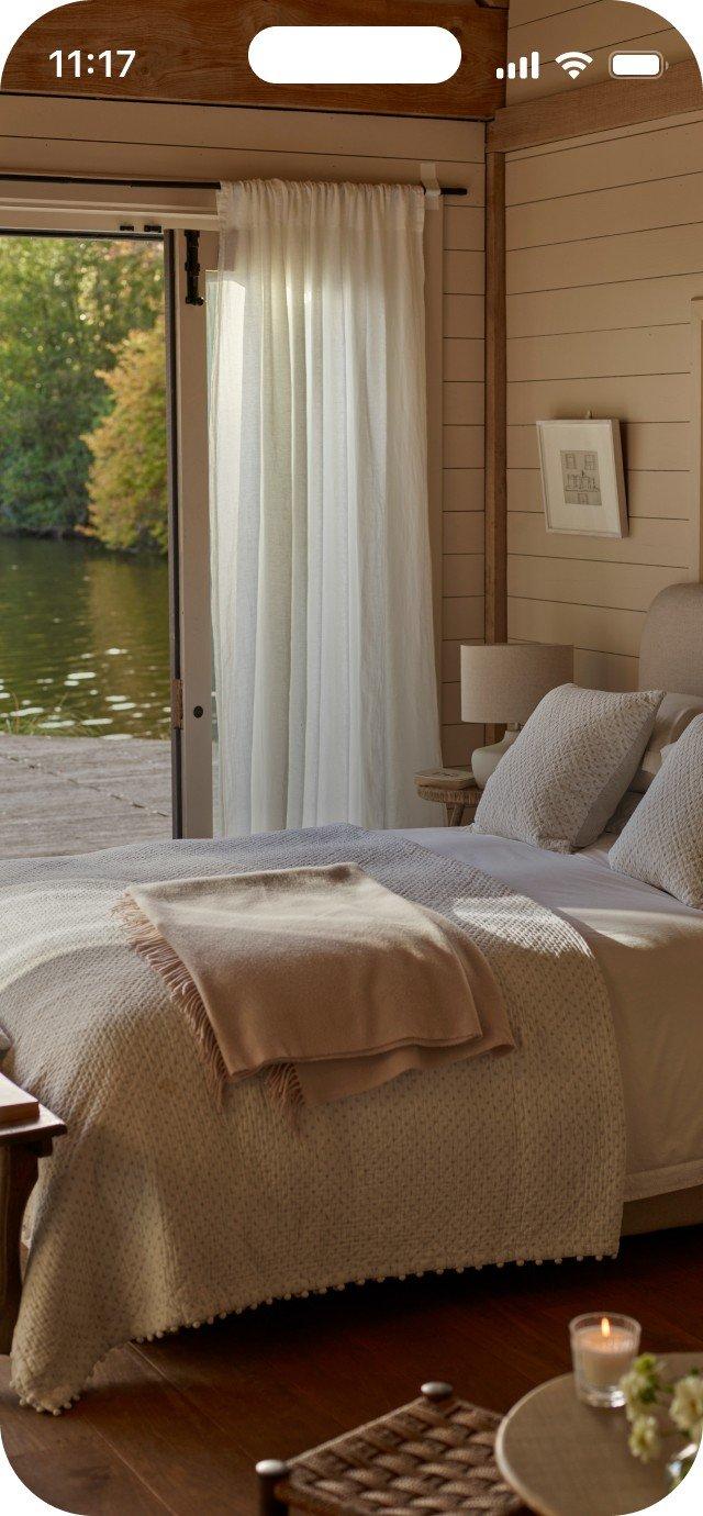 a bedroom with a bed and a window with a view of a lake