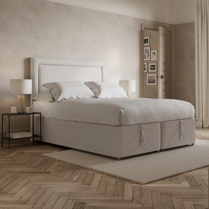 a bed with a white headboard and footboard in a bedroom