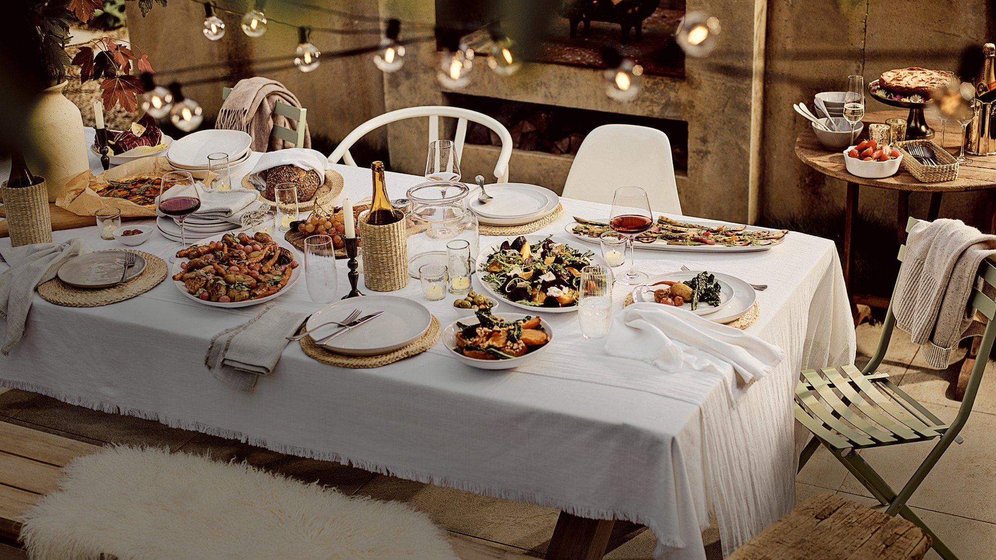 a table set with plates and bowls of food on it