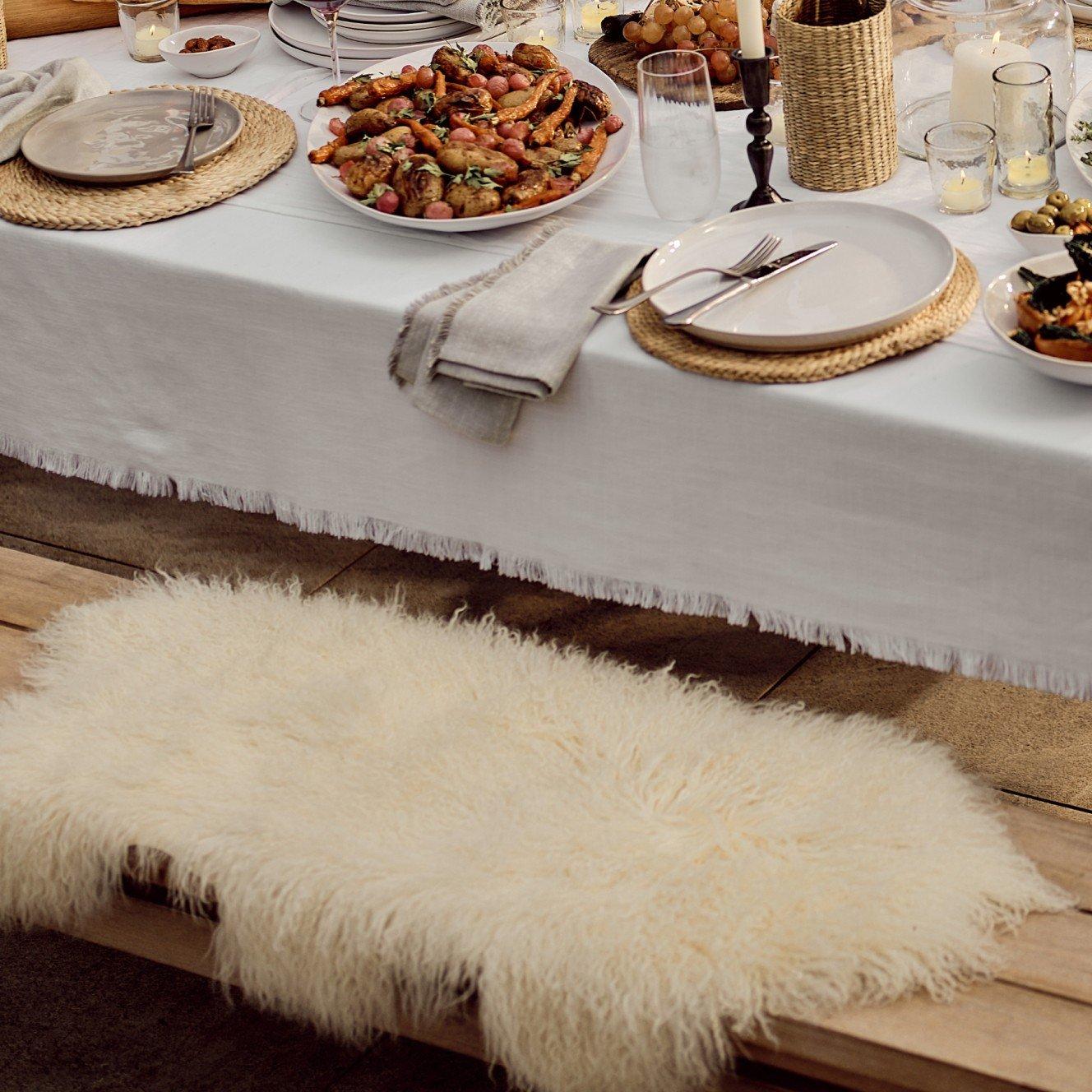 a table set with plates and bowls of food on a bench