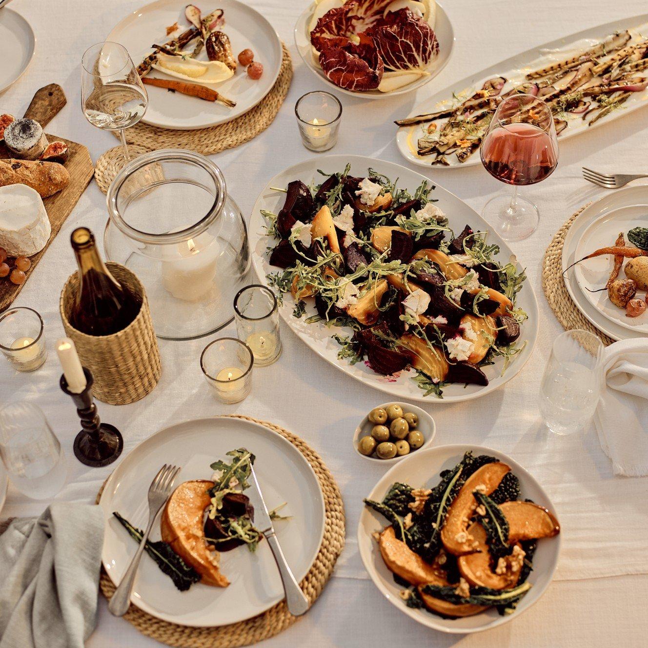 a table with plates of food and wine on it