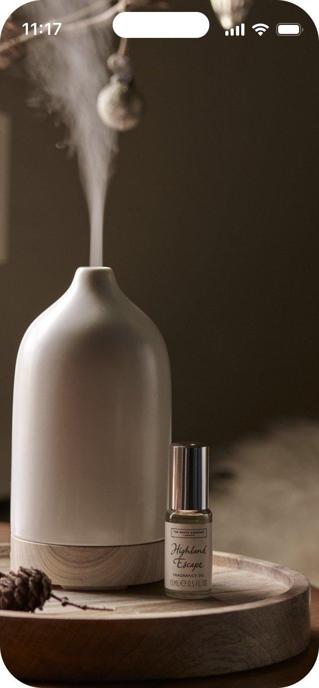 a close up of a diffuser with a bottle of essential oil