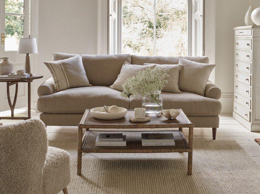 a living room with a couch, coffee table, and a table