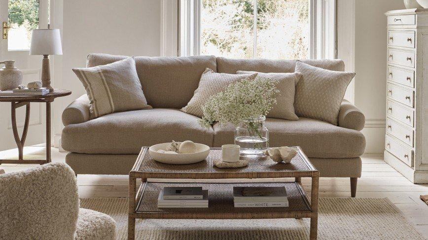 a living room with a couch, coffee table, and a table