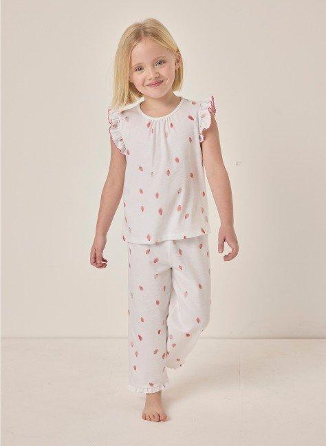 a little girl in white pajamas and a pink flower print