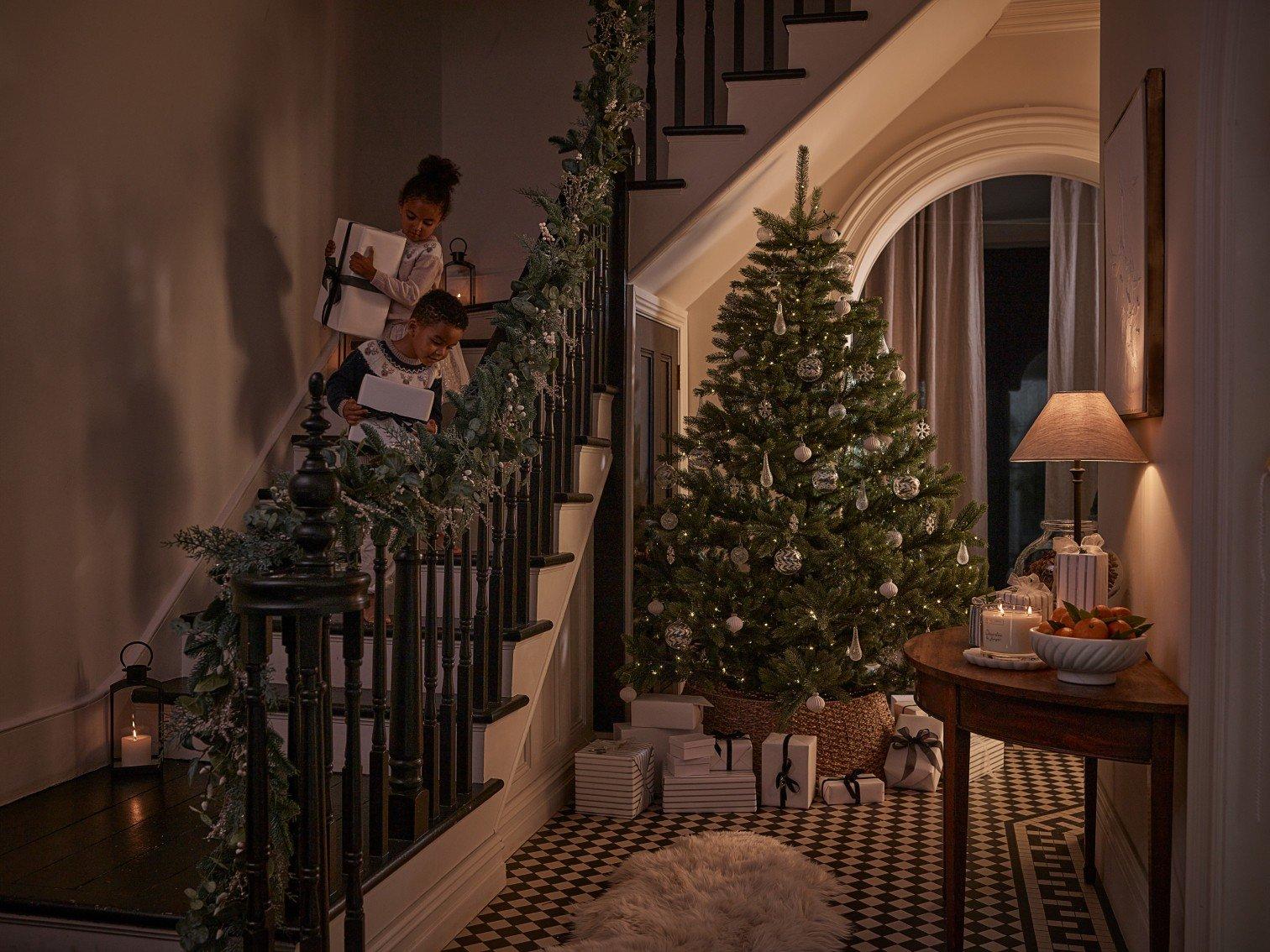 two children are sitting on the stairs of a house