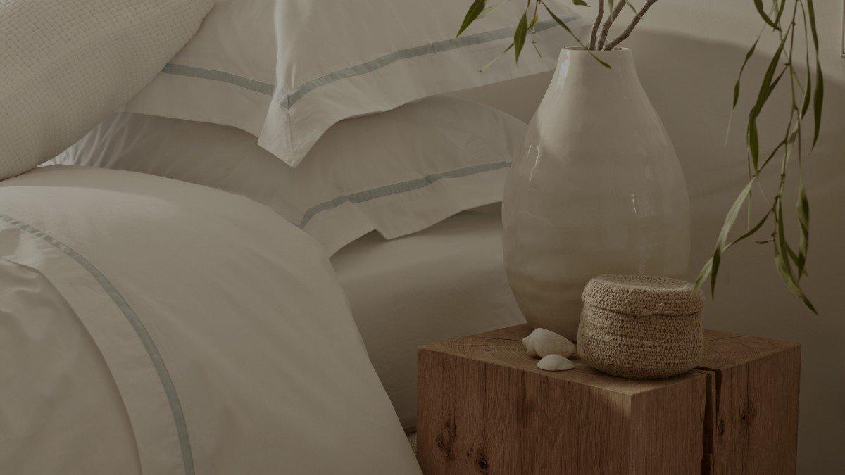 a vase of a white vase sitting on a wooden block