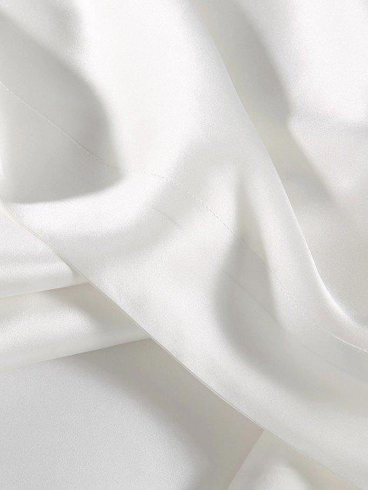 a close up of a white sheet with a white cloth