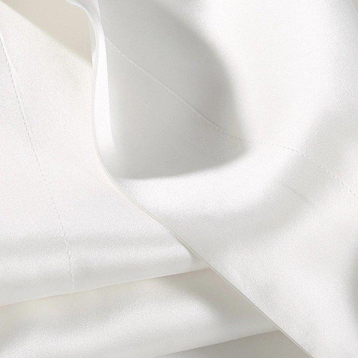 a close up of a pile of white fabric sheets