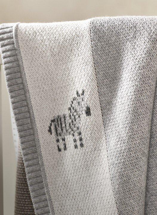 a blanket with a zebra embroidered on it