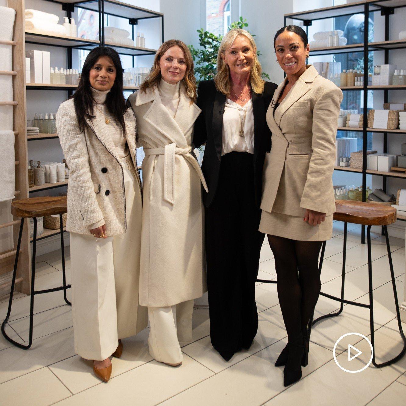 three women standing next to each other in a store