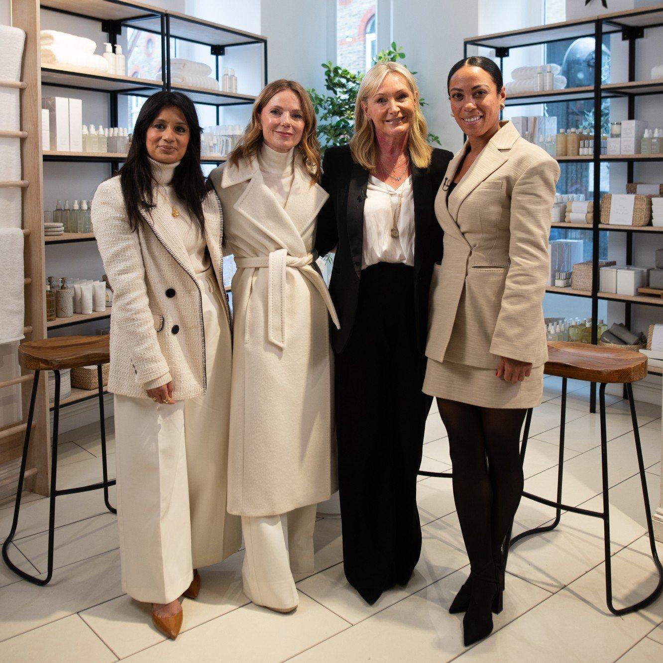 three women standing next to each other in a store