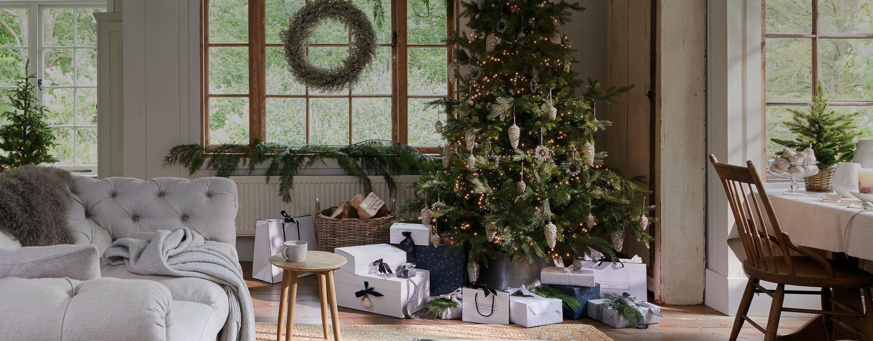 christmas living room with decorations and presents under a tree