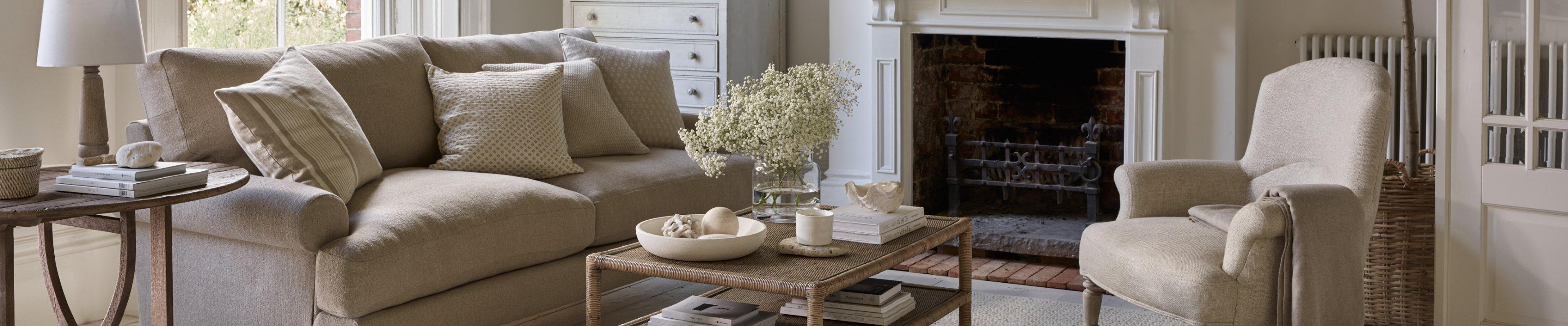 a living room with a couch, coffee table, and a fireplace