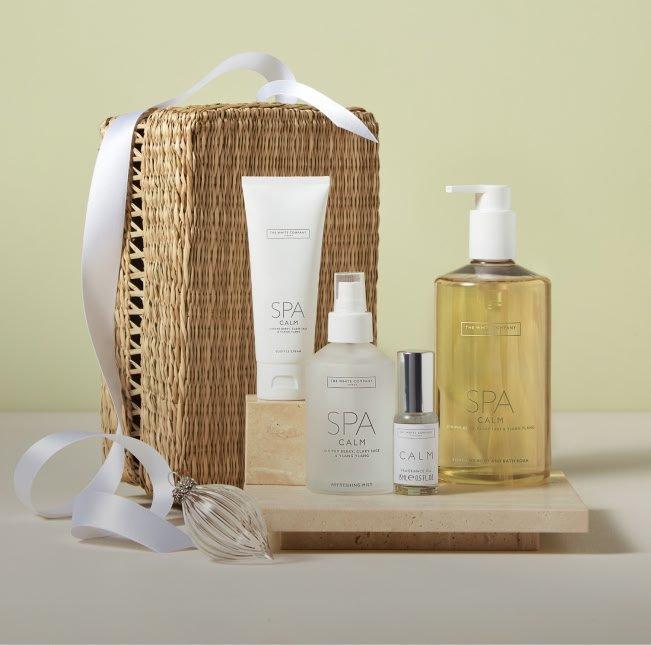 a basket with a bottle of spa products on it