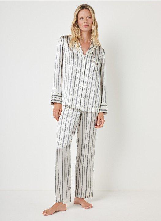 the model wears a striped pajama set with a white stripe