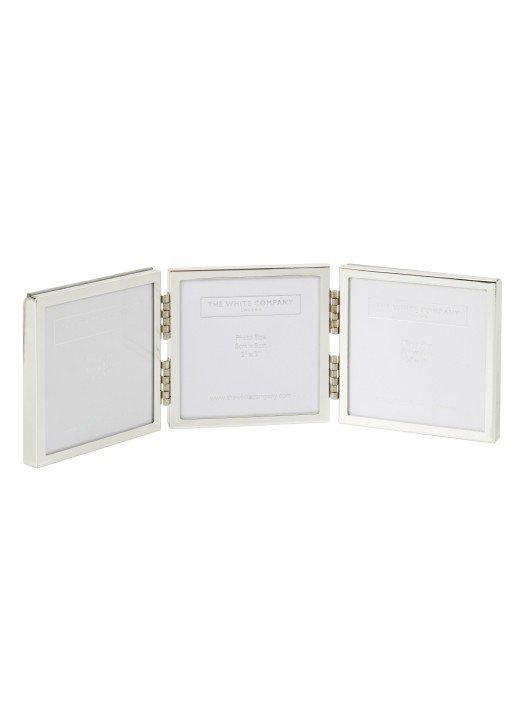 three silver picture frames with white frames on a white background