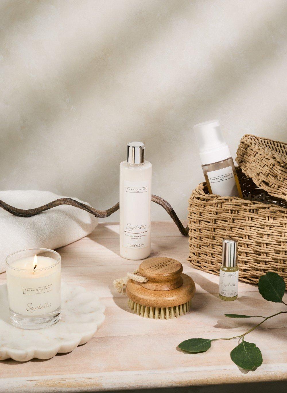 a table with a basket of items on it and a candle