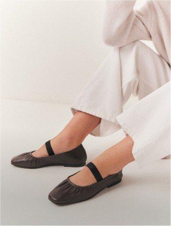 a pair of brown ballerina flat shoes