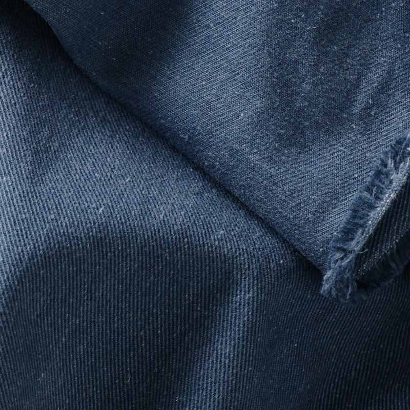 a close up of a blue fabric with a white stripe