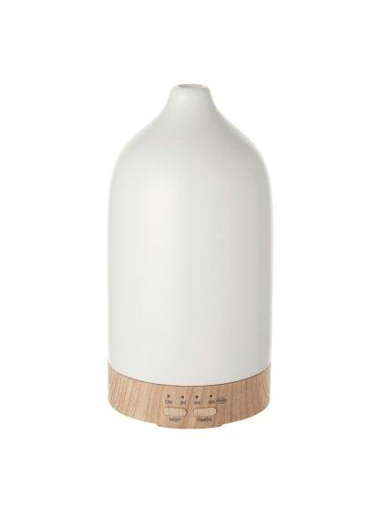 a white and wood aroma diffuser on a white background