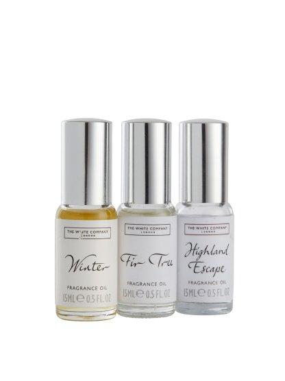 three bottles of perfume on a white background