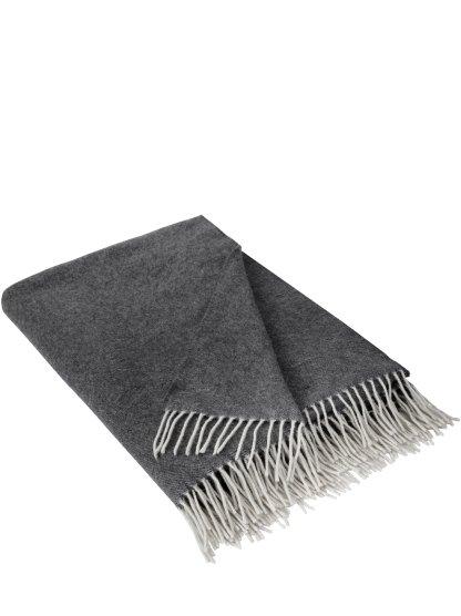 a gray and white blanket with fringes on it