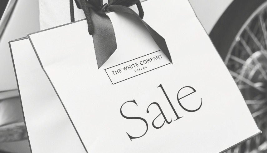 a black and white photo of a sale sign on a bag