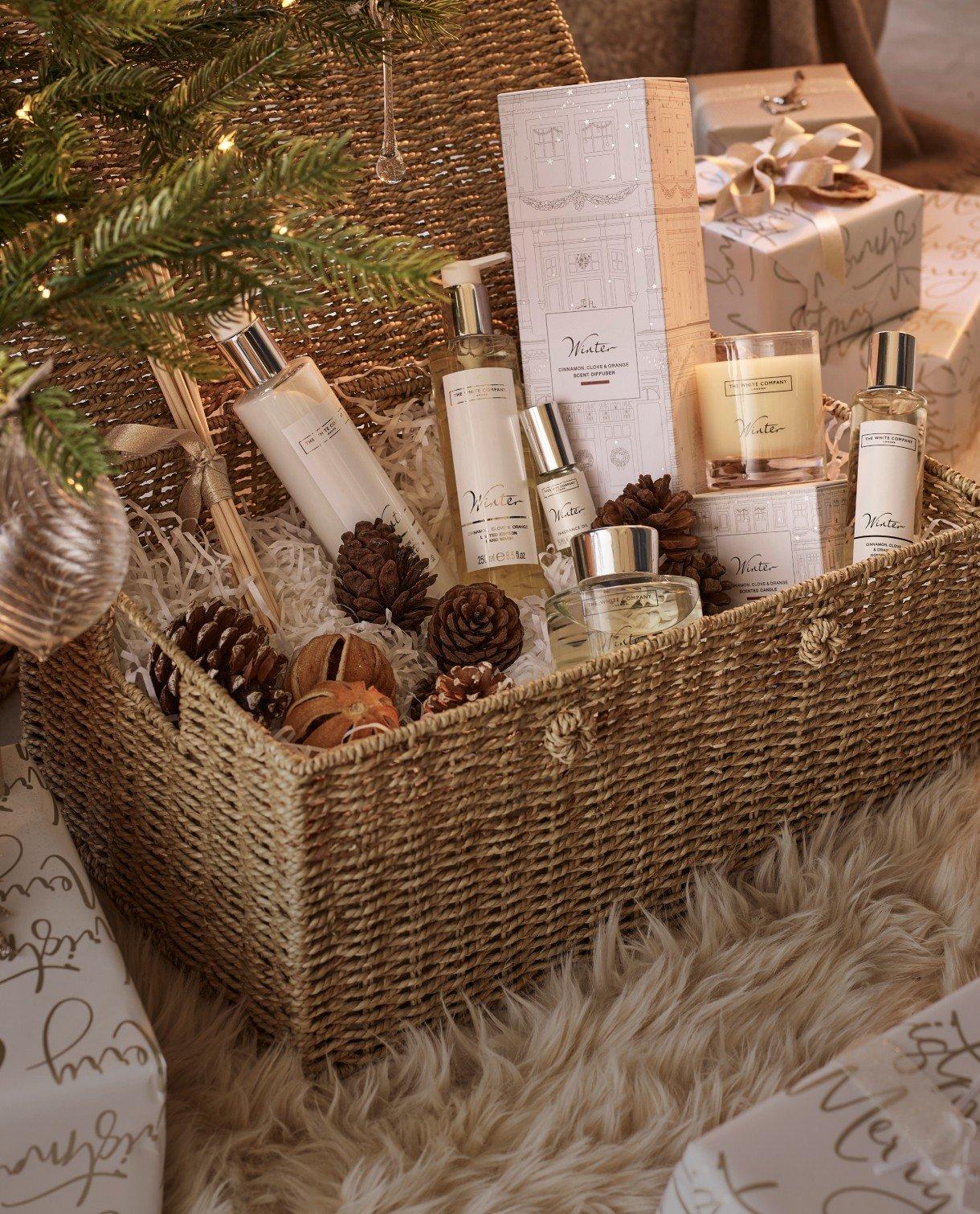 a basket filled with various items of beauty and a christmas tree