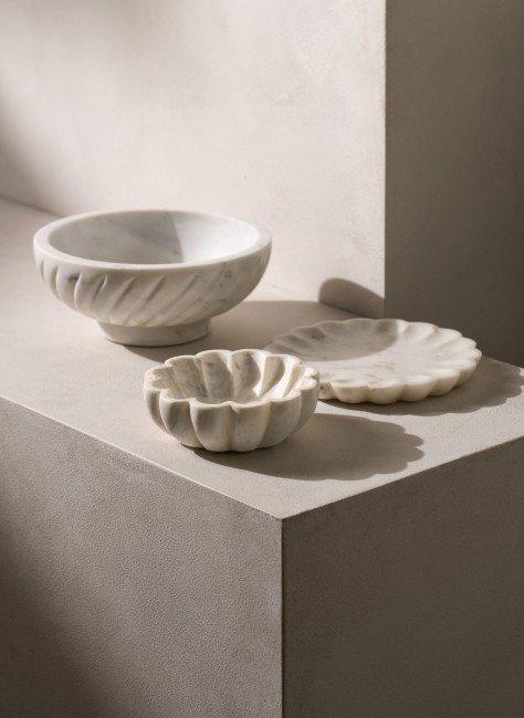 a white bowl and two small bowls on a counter