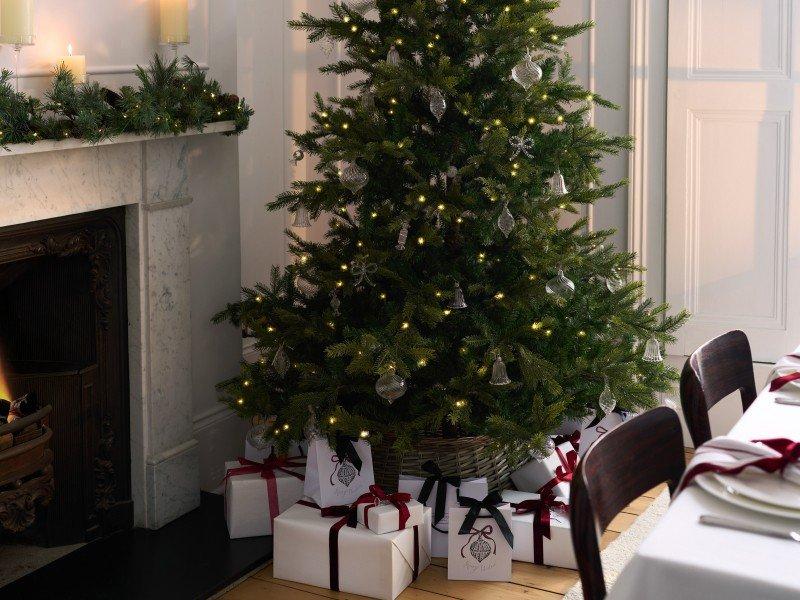 a christmas tree in a room with presents under it