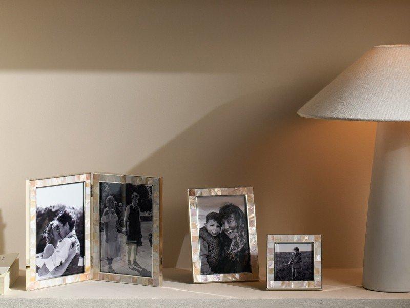 a shelf with a lamp, a bowl, and a picture frame