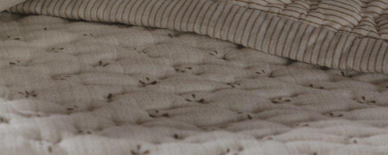 a blurry image of a bed with a lot of pillows on it