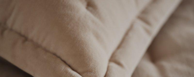 a close up of a person's hand holding a piece of fabric