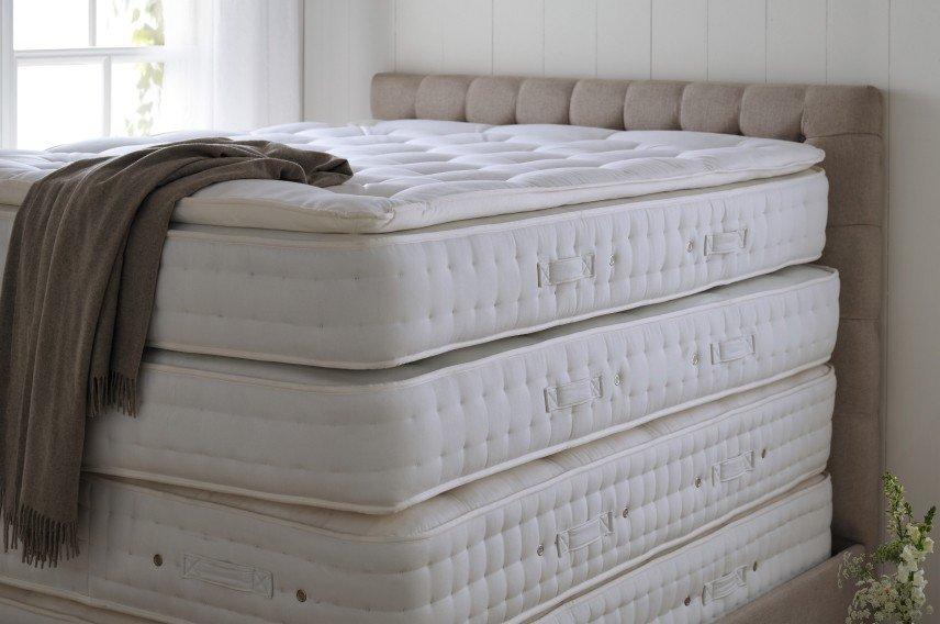 a stack of four mattresses stacked on top of each other