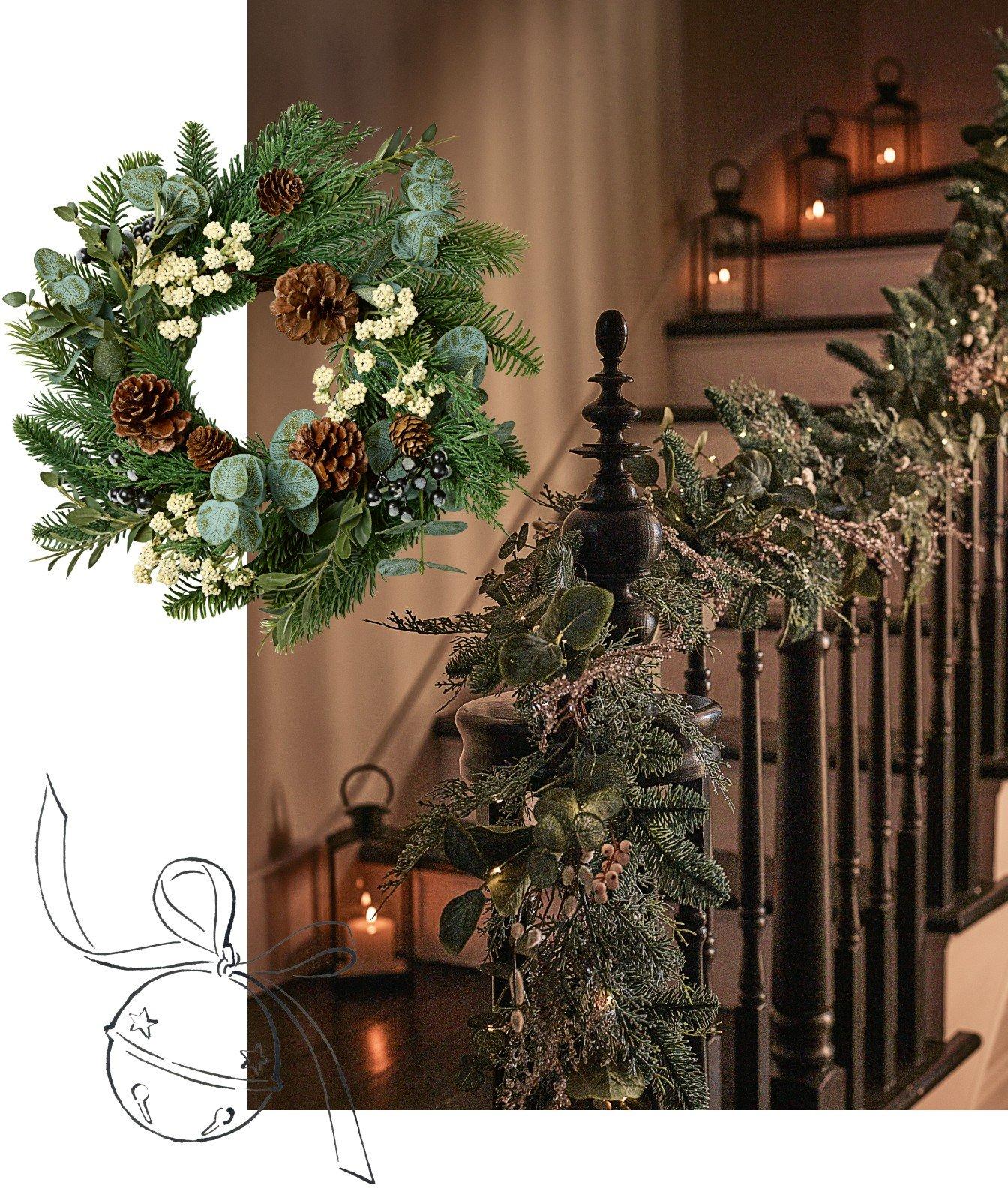 a wreath and garland on the railing of a staircase