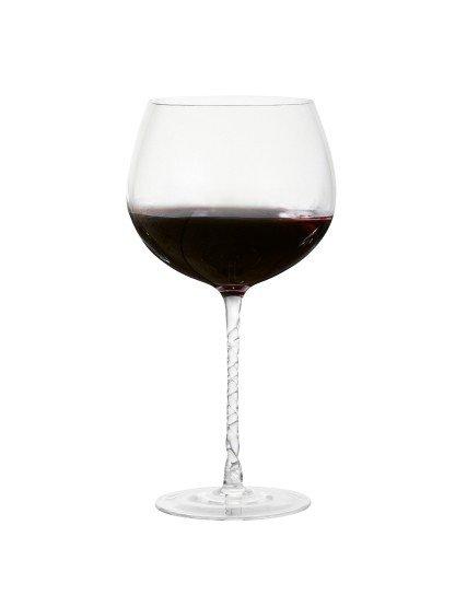 a glass of wine on a white background with a white table