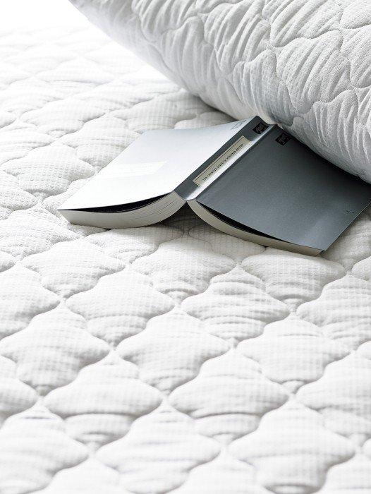 a close up of a white pillow on a bed