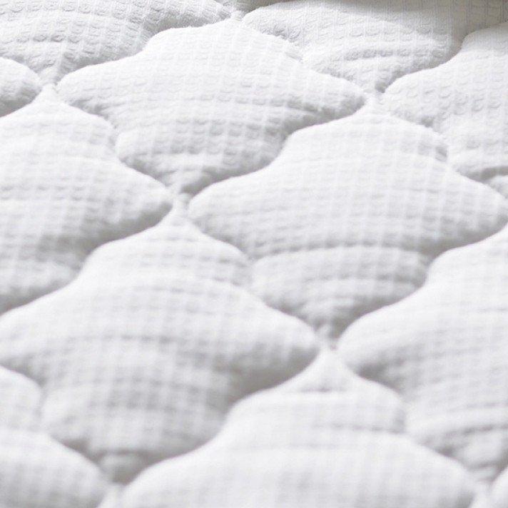 a close up of a white feather pillow and a white feather pillow