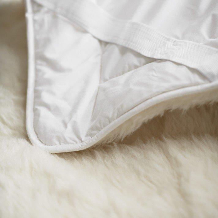 a close up of a white feather pillow and a white feather pillow