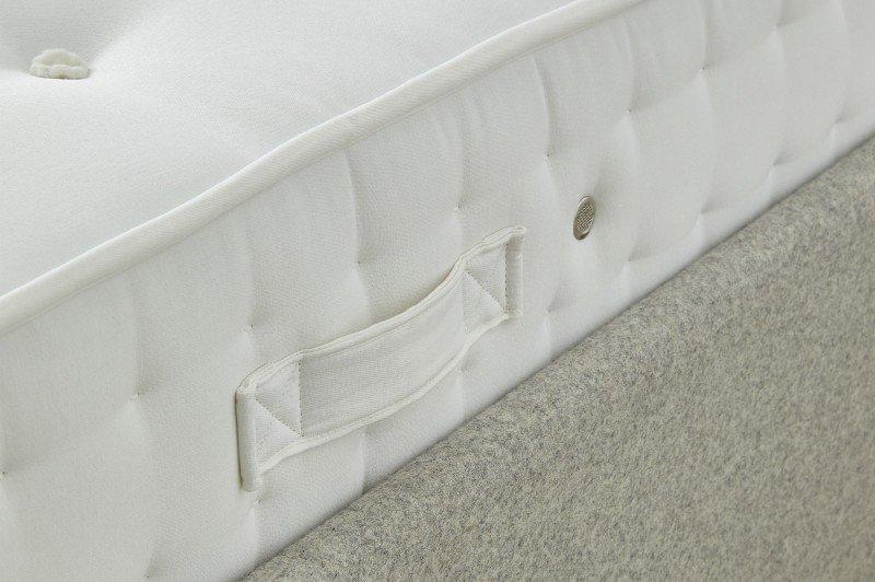 a close up of a mattress with a button on the side