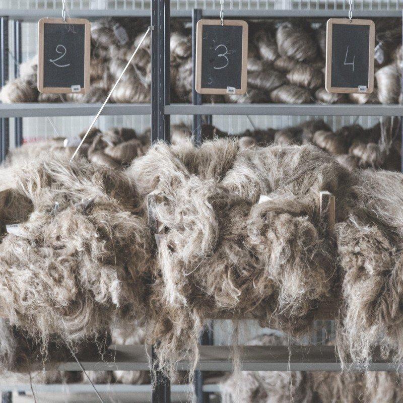a pile of wool in a room with a sign that says "wool"