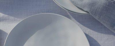a close up of a white plate sitting on a table
