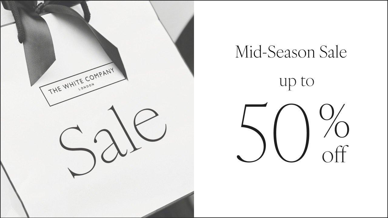 a white box with a black ribbon and a 50 % off sign