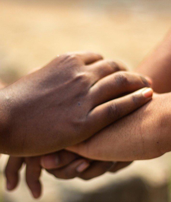 two hands holding each other together in a handshake