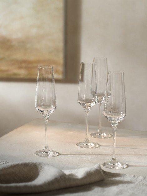 a group of four wine glasses sitting on a table