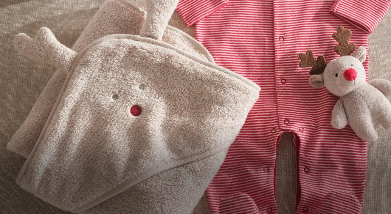 a plate of cheese and crackers on a table with a bottle of wine