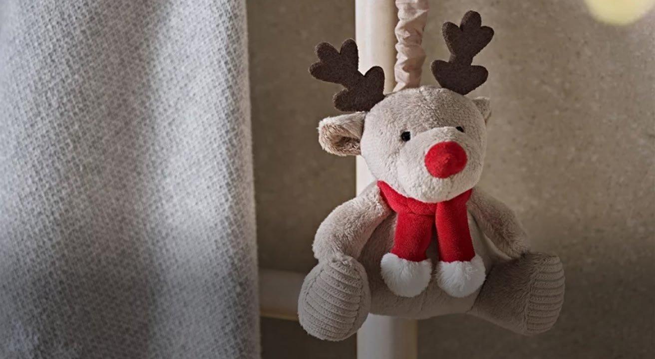 a woman holding a white mug with a heart on it