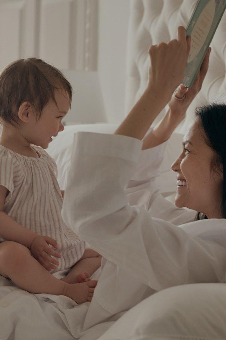 a woman and boy hugging each other in a field